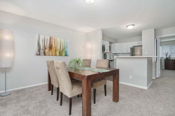 Kenilworth apartment dining room with wood table, large paper lights, and large artwork.