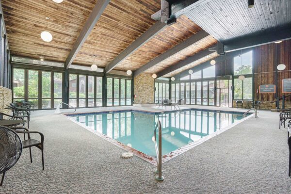 Kenilworth apartment pool area with large windows and vaulted ceilings.