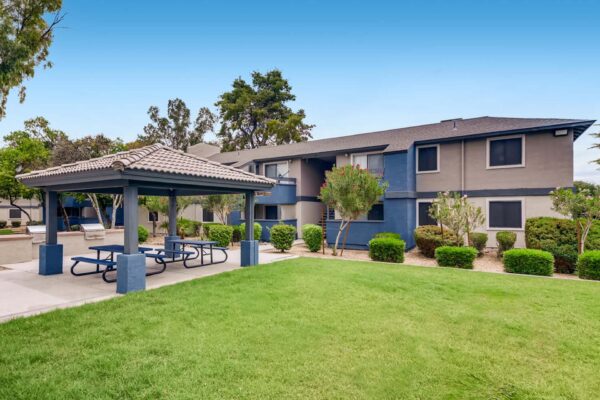 Latitude apartments with lush landscaping and gazebo with picnic tables.