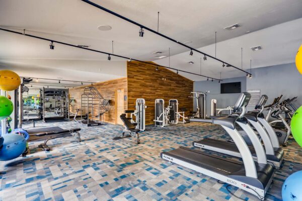 Latitude apartments fitness center with cardio machines and weight equipment.