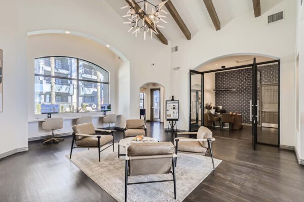 Mandarina apartments lobby with leather arm chairs, leasing office with glass doors, and sculptural light fixture.