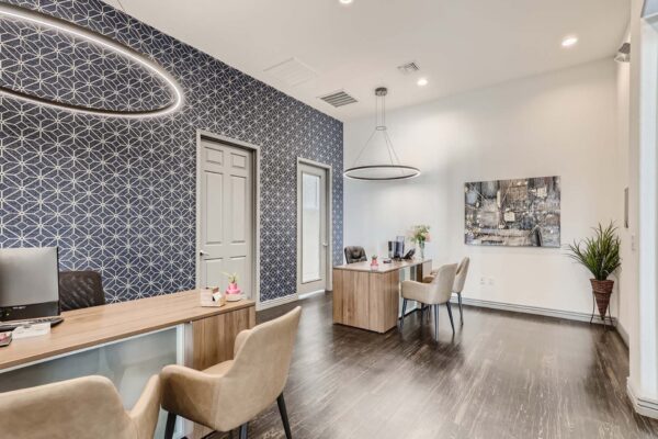 Mandarina apartments office with comfortable leasing desks and pattern wallpaper.
