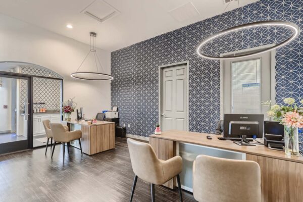 Mandarina apartments leasing office with comfortable leasing desks and pattern wallpaper.