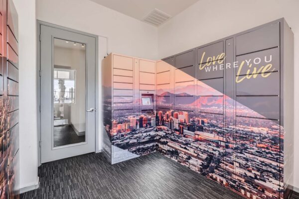Mandarina apartments mail room with mailboxes and city mural.