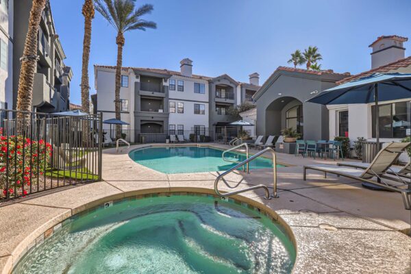 Mandarina apartments pool area with hot tub and lounge chairs.