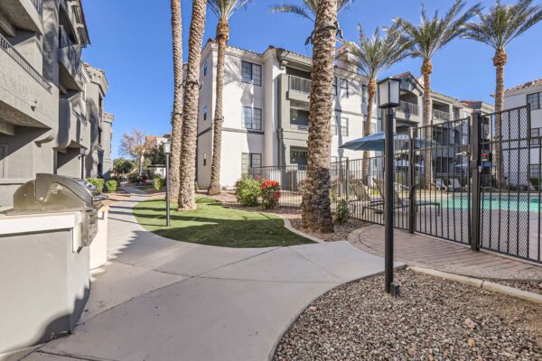 Mandarina apartments outdoor space with gated pool and built in BBQ grill.