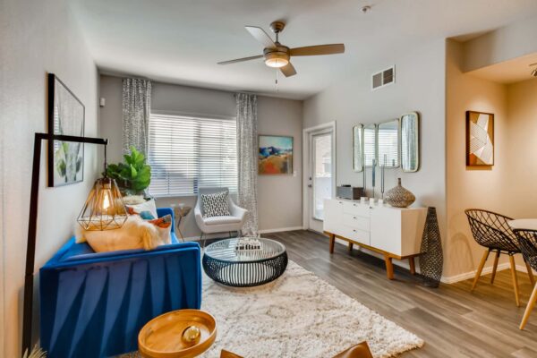 Mandarina apartment living room with large windows, bright furniture and eclectic decor.