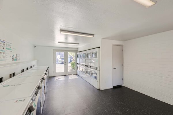 Omnia on Thomas apartments laundry room with washers and dryers.