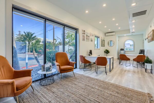 Omnia on Thomas apartments lobby with leasing desks, plush armchairs, and large windows.