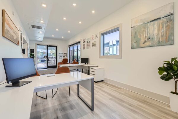 Omnia on Thomas apartments leasing office with computer desks and comfortable chairs.
