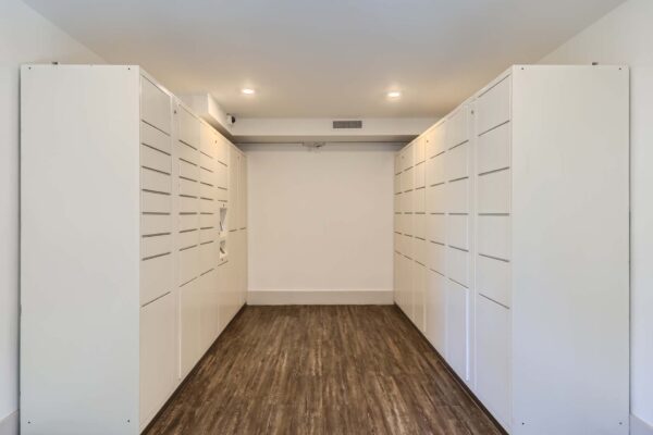 Omnia on Thomas apartments mail room with wood style floors and white mailboxes.