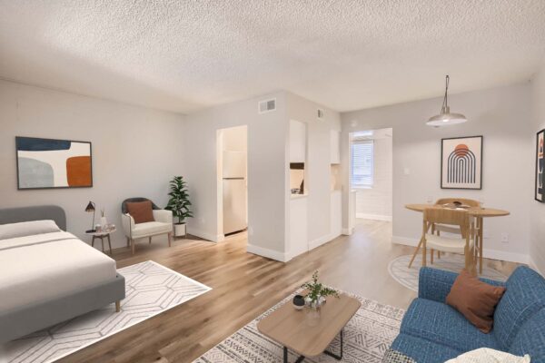 Omnia on Thomas apartments living area with wood style floor, plush seating, and dining table with stools.