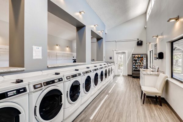 Overlook at Sunset Point apartment laundry room with washers, dryers, and snack machine.
