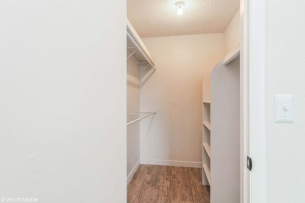 Overlook at Sunset Point apartment closet with wood style floor and built in shelves.