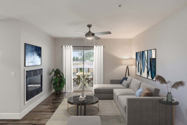 Pavilions at Arrowhead apartment living room with plush seating, ceiling fan, fireplace, and door to balcony.