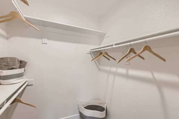 Pavilions at Arrowhead apartment closet with built in shelves and hangers.