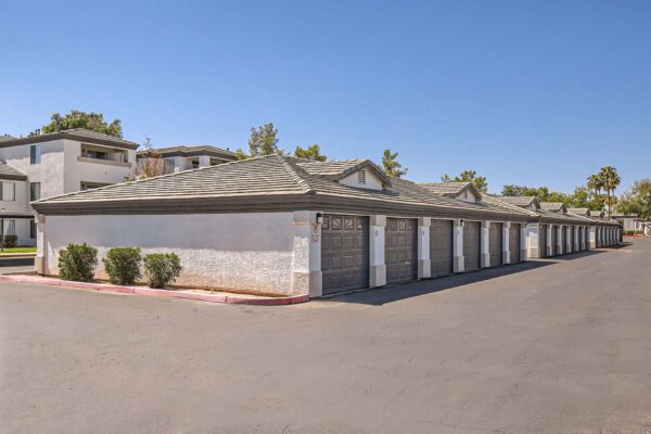 Pavilions at Arrowhead apartments parking area with large garages.