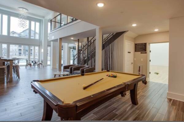 Prairie View at Village West apartments game area with billiards table and racquetball court.
