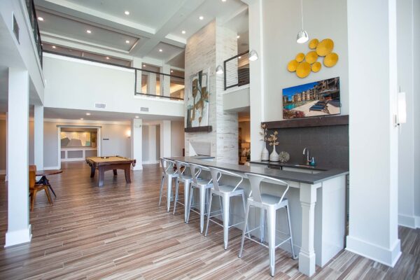 Prairie View at Village West apartments pub with bar, pool table, and airy vaulted ceilings.