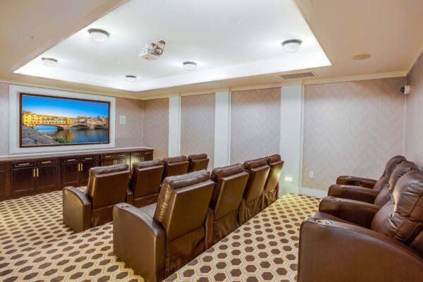 Prairie View at Village West apartments theater with plush leather stadium seats and large TV.