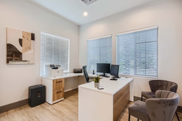 Springs at Alta Mesa apartments leasing office with comfortable chairs and computer desk.