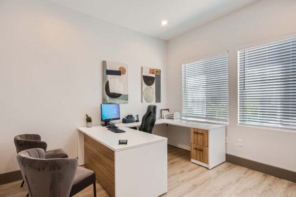 Springs at Alta Mesa apartments leasing office with computer desk and comfortable chairs.