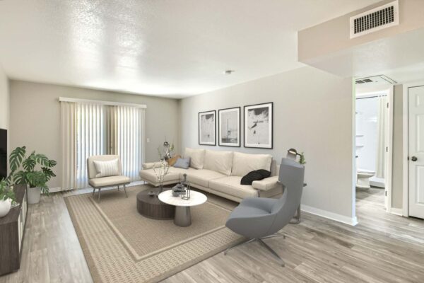 Tempe Vista apartment living room with plush seating, framed artwork, and balcony door.