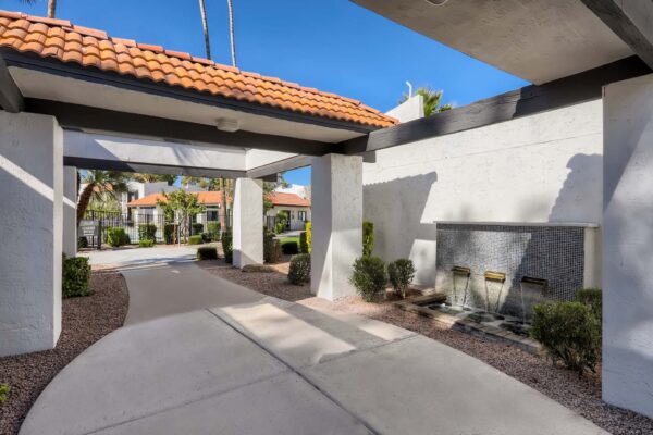 Tempe Vista apartments outdoor breezeway with lush landscaping and water features.