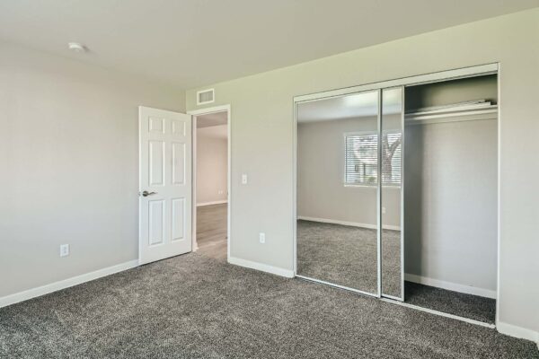 Tempe Vista apartment bedroom with plush carpet and large closet.