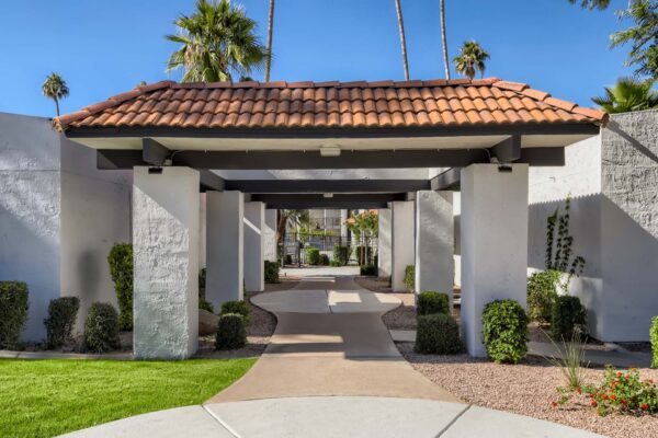 Tempe Vista apartments breezeway with classic architecture and lush landscaping.