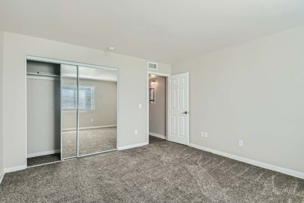 Tempe Vista apartment bedroom with plush carpet and large closet.