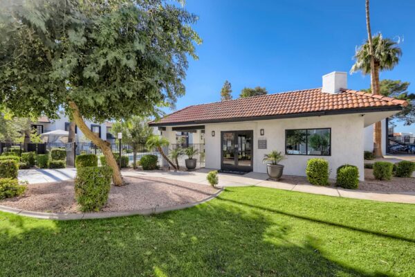Tempe Vista apartments clubhouse with lush landscaping and shady trees.