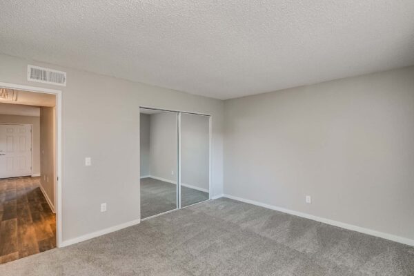 Tempe Vista apartment bedroom with plush carpet and large closet.