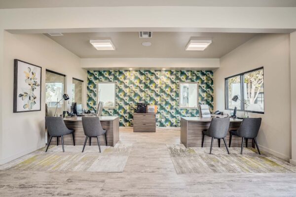 Tempe Vista apartments leasing office with leasing desks and pattern wallpaper.