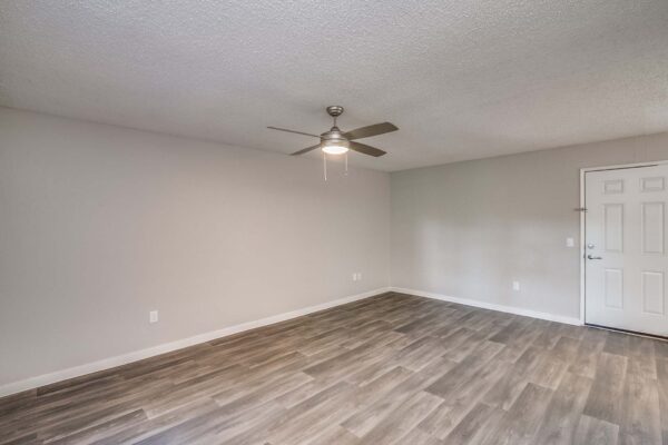 Tempe Vista apartment living area with wood style floor and ceiling fan.