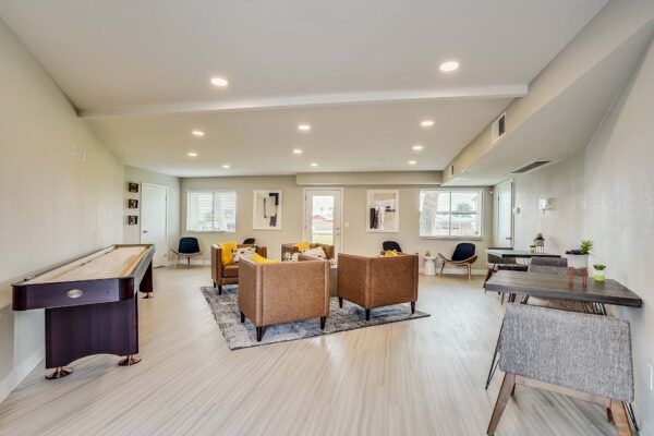 Tempe Vista apartments clubhouse with shuffleboard table and comfortable seating.
