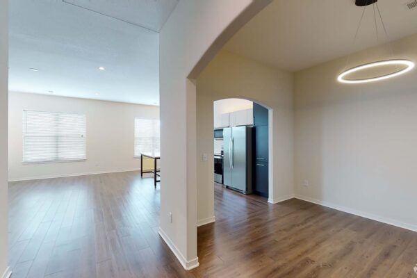 The Locale apartment living area with wood style floor, modern kitchen, and dining room.