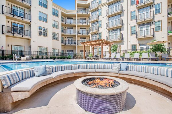 The Locale apartments pool area with fire pit and round bench seats.