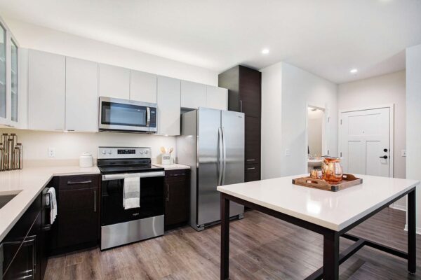 The Locale apartments with wood style floor, two tone cabinets, and stainless steel appliances.