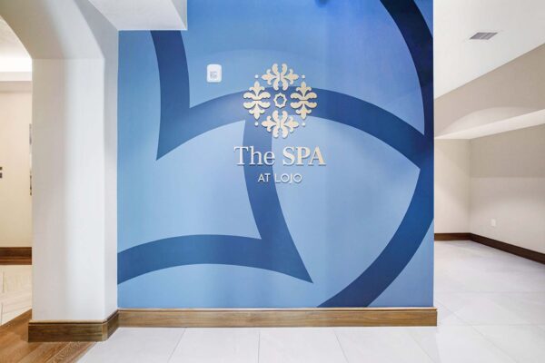The Locale apartments spa with bright blue signage.