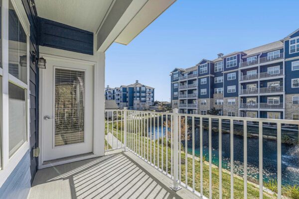 Village West apartment balcony overlooking pond with fountain.