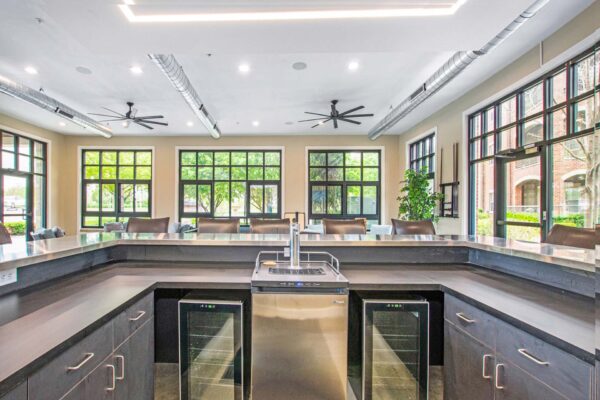 Village at Mission Farms apartments community bar with polished counter top, beer tap, and wine fridges.