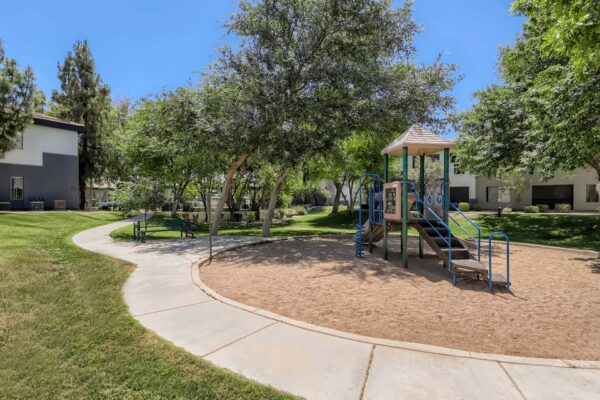 Villas at Mountain Vista Ranch apartments playground with sandy play area and metal playground equipment.