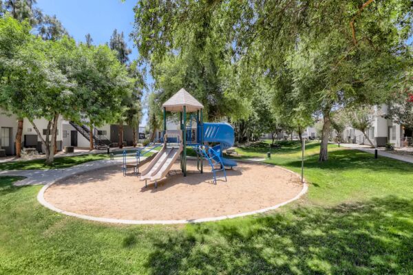Villas at Mountain Vista Ranch apartments playground with sandy play area and metal playground equipment.