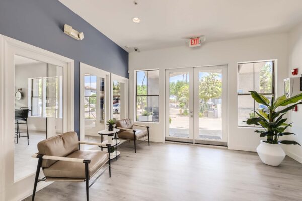 Villas at Mountain Vista Ranch apartments lobby with plush chairs and bright windows.