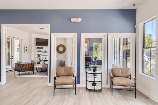 Villas at Mountain Vista Ranch apartments lobby with plush chairs and door to clubroom.