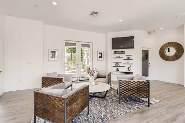 Villas at Mountain Vista Ranch apartments clubroom with plush chairs, eclectic decor, and TV.