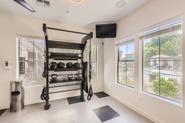 Villas at Mountain Vista Ranch apartments with calisthenics equipment, TV, and large windows.