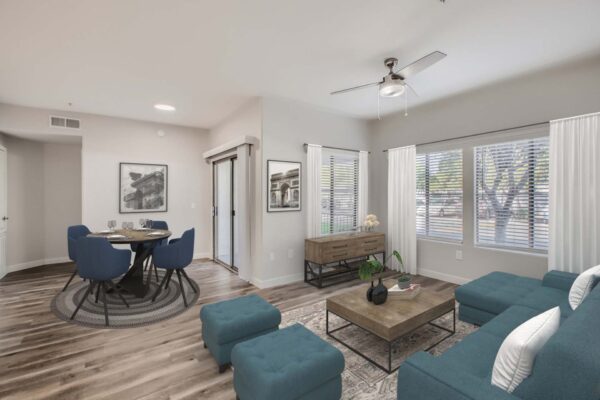 Villas at Mountain Vista Ranch apartment living room with wood style floor, plush seating, and large windows.