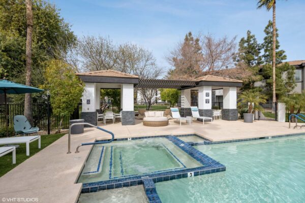 Villas at Mountain Vista Ranch apartments pool area with lounge chairs, day beds, and hot tub.